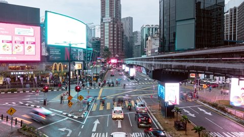 Kuala Lumpur, Malaysia - December 01 2020: A monorail train travel through the crowded Bukit Bintang intersection in the heart of Kuala Lumpur downtown. Shot as a time lapse video with zoom out motion