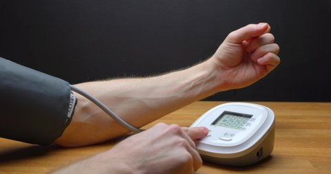 Man measuring blood pressure closeup