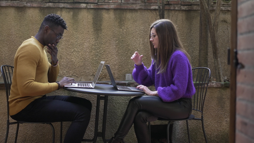Diverse young millennial couple using laptop computer together, a Person Video by Bricolage