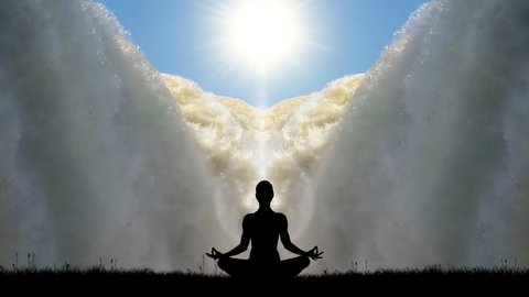 A female silhouette meditating in the lotus position in front of a giant waterfall with the sun shining down.
