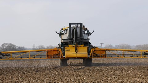 Perry Green, Much Hadham, Hertfordshire, UK. March 1st 2021. Farmer using a self propelled crop sprayer in a field in early spring.