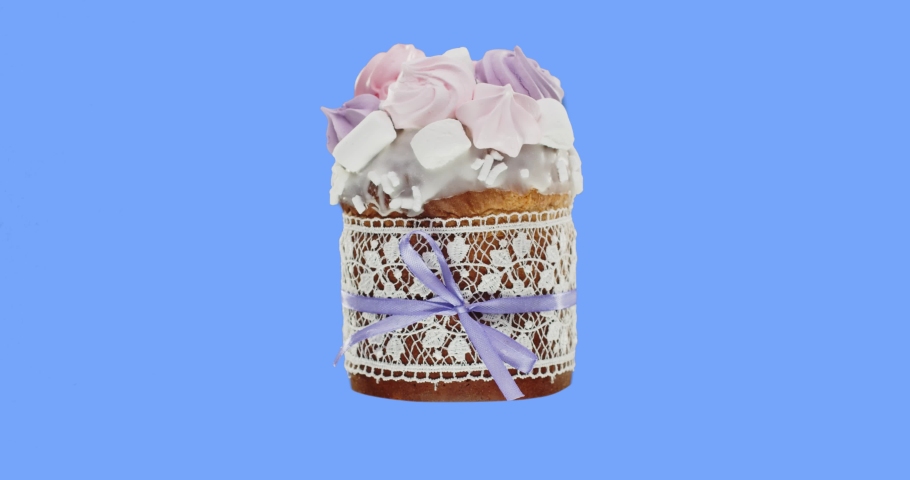 Easter cake, decorated with icing and colorful meringues, wrapped in a sweet edible ribbon