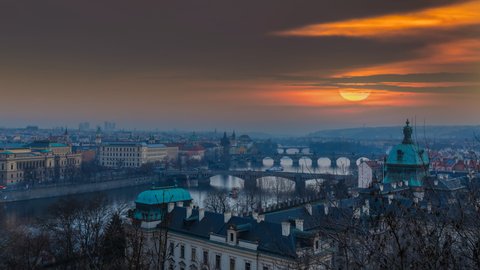Prague skyline aerial view, beautiful Prague sunset time lapse from day to night, view of city old town river and bridge in 4k. Prague charles bridge.