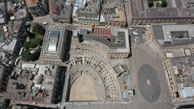 Lecce,Puglia,Italy Beautiful panoramic aerial 4K video from flying drone to Roman Amphitheatre, arena Lecce. Historic city center, Cathedral of Maria Santissima Assunta, on a beautiful summer day.