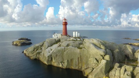 Svenner Lighthouse on Norwegian coast Island, drone footage pulls back revealing the lighthouse keepers village