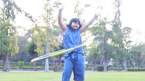 Girl playing Hula hoop in the grass - Powered by Shutterstock - Get 15% off with code: PIKWIZARD15