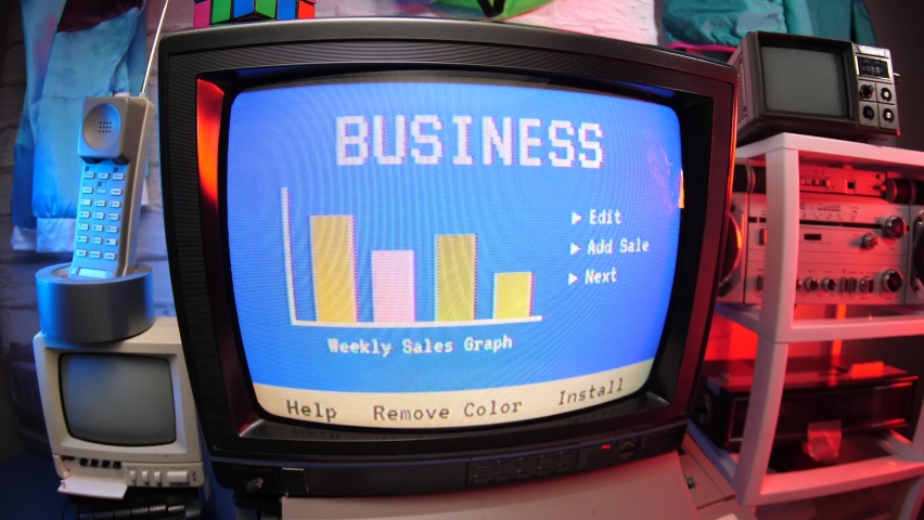 Business graphs and charts on an old vintage computer screen from the 80s 90s. Retro way of seeing sales stats. Royalty-Free Stock Footage #1068343679