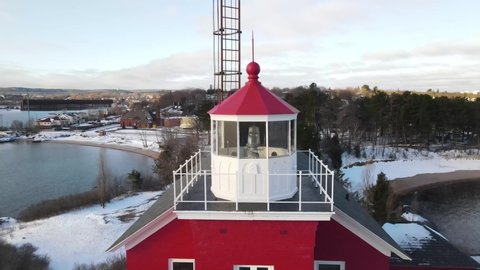 Red lighthouse located in Marquette, Michigan in the winter.