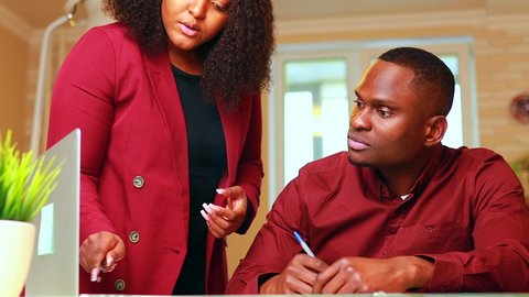 african american man and woman in stylish outfit marsala jacket work together