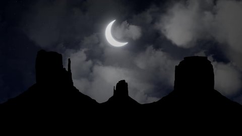 Monument Valley Navajo Tribal Park by Night with Crescent Moon and Clouds, Arizona, Utah, USA