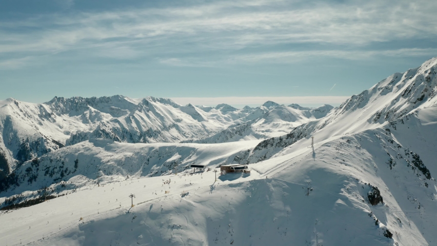 Ski Resort Chairlift atop Snowy Mountaintop in Europe Alps, Aerial