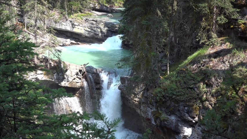 In Banff National Park, white water rapids in Johnston Canyon, foaming waterfall in rocky gorge, static Royalty-Free Stock Footage #1068365660