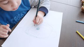 Little Boy Drawing stock video is a great piece of video that contains a little boy using colored pencils to draw a picture. You can use this 3840x2160 (4K) bit of video in any project.