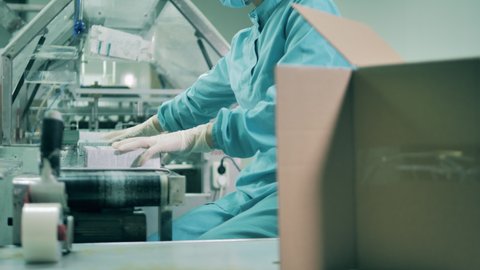 A specialist is packing medical products into boxes