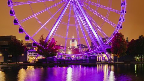 View of the night Montreal in Canada and the Ferris wheel. The city is beautifully lit with lights