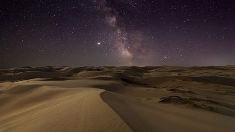 Timelapse of desert under the night starry sky in the Arabian Empty Quarter Desert, UAE. Rub' al Khali