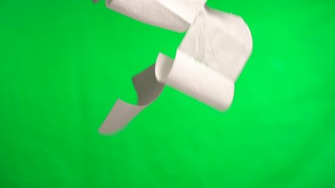 Falling Natural Toilet Paper on Green Background. Slow motion. Chromakey Green Screen Background