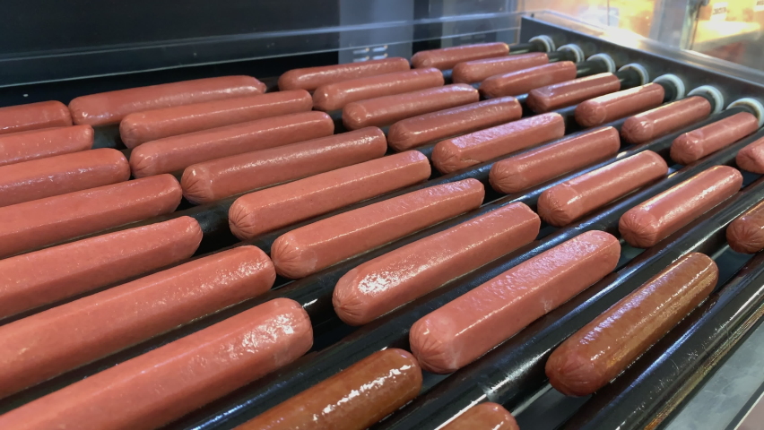 Rotating Hot Dog Loader Grill in Motion at a Restaurant