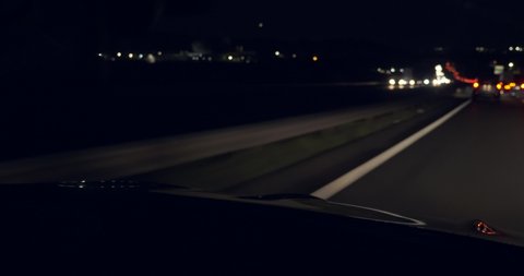 POV Windshield View Driving Car Fast on Highway at Night. France Europe