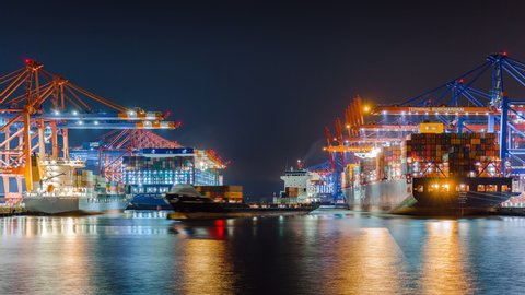 HAMBURG, GERMANY - 02 22 2021: Container ship loading and unloading in deep sea port, business logistic import and export freight transportation, Container loading cargo freight ship, Time Lapse