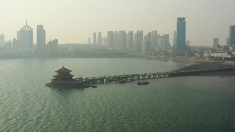 sunset time qingdao city famous beach bay pagoda pier aerial panorama 4k china