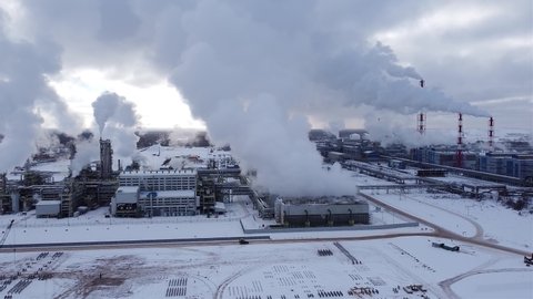 chemical plant aerial video. smoking chimneys of a large chemical ammonia plant in winter.