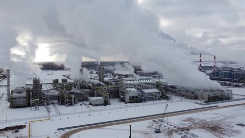 chemical plant aerial video. smoking chimneys of a large chemical ammonia plant in winter.