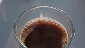 steam from hot coffee in a glass slow motion video