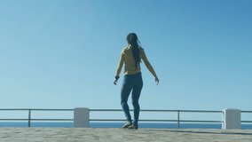 Animation of word wow over woman dancing on promenade by the sea. Digital interface global sport and performance concept digitallygenerated video.