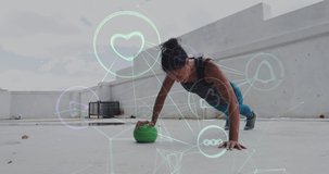 Animation of technological icons over woman exercising with a ball. Digital interface global sport and performance concept digitallygenerated video.