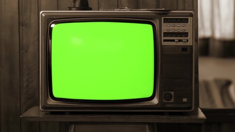 Vintage Television Set Green Background with Noise and Static. Sepia Tone. You can replace green screen with the footage or picture you want with “Keying” effect in AE (check out tutorials). 4K.