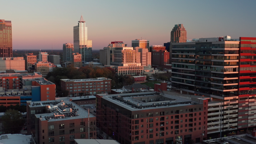 Aerial shot approaching downtown Raleigh, North Carolina at sunset. | Shutterstock HD Video #1068413363