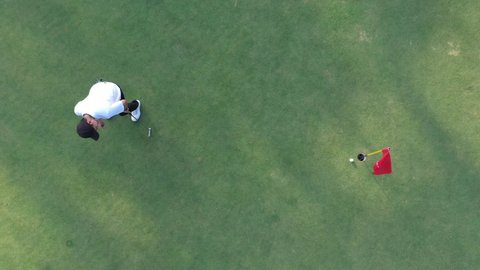 Top view of asian male golf player failed strike on the golf course. Fail, failure, bad day concept.
