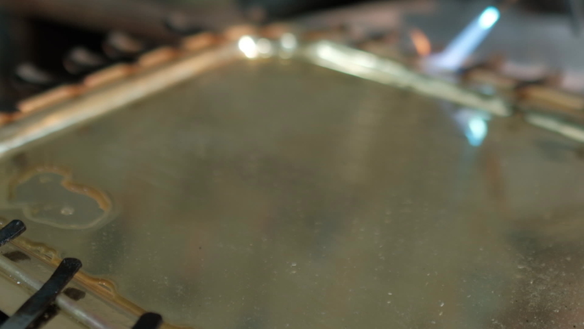 Heating border of the tray with blow torch. The tray is full of water to prevent any damage for the base and to anneal it faster. Preparing Copper and Hand crafting a new design of silver plated tray.