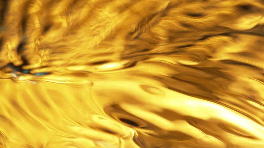Super Slow Motion Shot of Waving Golden Liquid Luxury Background at 1000fps.