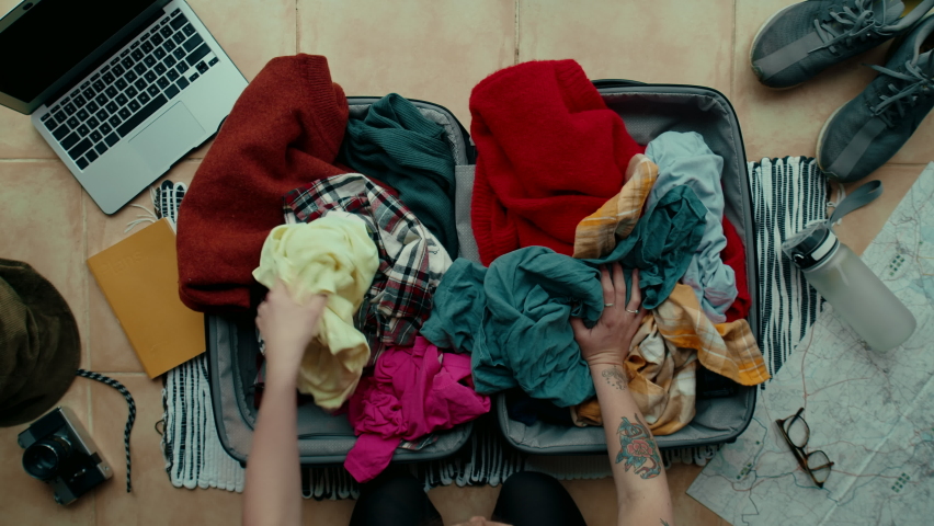 Top view on stressed and anxious traveller unpack suitcase, throw clothes out of travel bag. Make mess in apartment, worried, search for lost missing object. Happy unpacking to start holidays Royalty-Free Stock Footage #1068428906