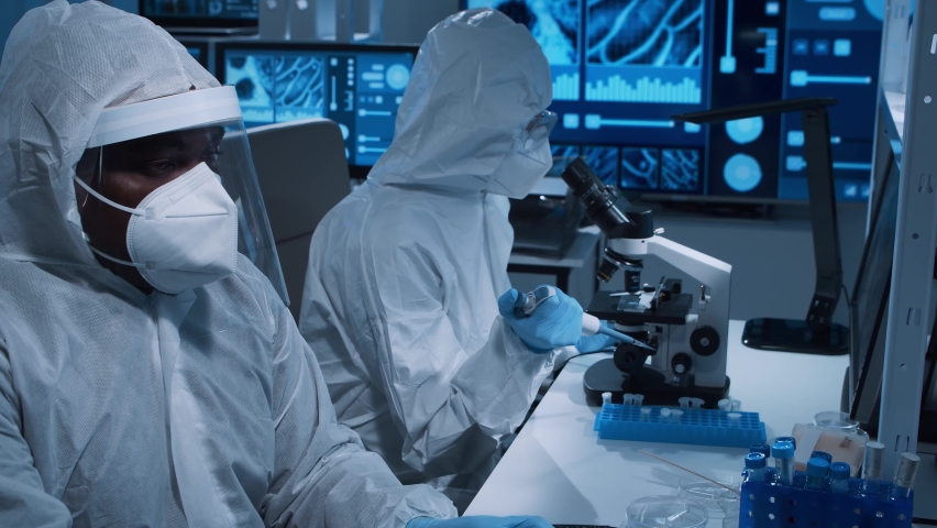 Diverse team of scientists is working on a vaccine in a modern scientific research laboratory. Genetic engineer workplace. Future technology and science concept.