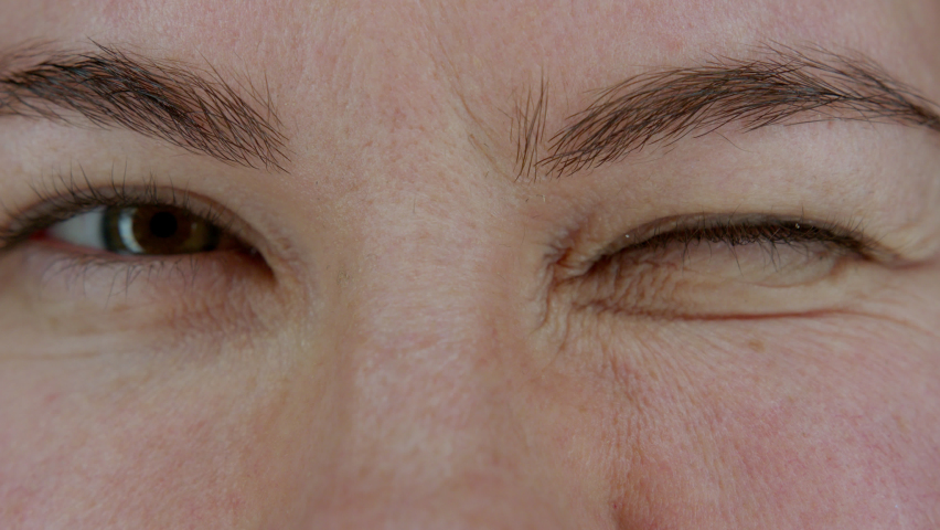Female eyes looking at camera and squinting. Close up