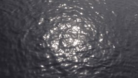 The reflection of sunlight in dark river water. Background. 4k video.