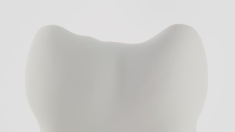 Dental Abstract, blue cloud covering a tooth on a white background. Oral Care, toothpaste, mouth wash, teeth whitening, and oral health care concept. High-quality 4k footage.