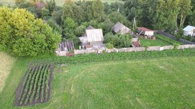 Aerial video from a drone, summer evening landscape, view of an old Russian village in beautiful nature. Vishur village, Udmurt Republic, Russia.
