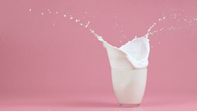Glass of milk with splash on color background - Powered by Shutterstock - Get 15% off with code: PIKWIZARD15