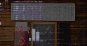 Animation of financial data processing with statistics over desk computer keyboard and smartphone. global finance and business concept digitally generated video.