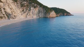 Aerial view of beautiful Milos beach and cliffs of Lefkada, Ionian island, Greece. Sunset golden sunlight and turquoise blue sea bay