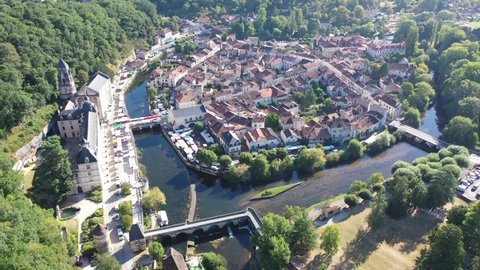 Scenic drone view of Brantome en Perigord on Dronne river with former Benedictine abbey on sunny summer day, Dordogne, France
