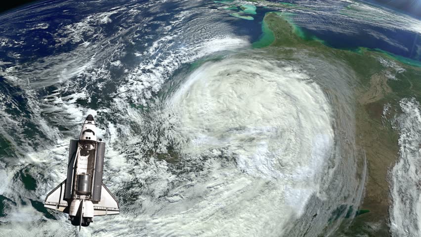 The Space Shuttle above the Earth and a hurricane in the background.