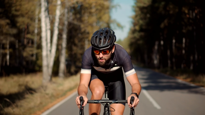 Fit Athlete Workout Training Cycling For Triathlon Competition.Sport Concept.Hard Workout.Triathlete Cyclist Training On Bicycle.Cyclist Fitness Riding On Road Bike And Getting Ready For Triathlon. | Shutterstock HD Video #1068482810