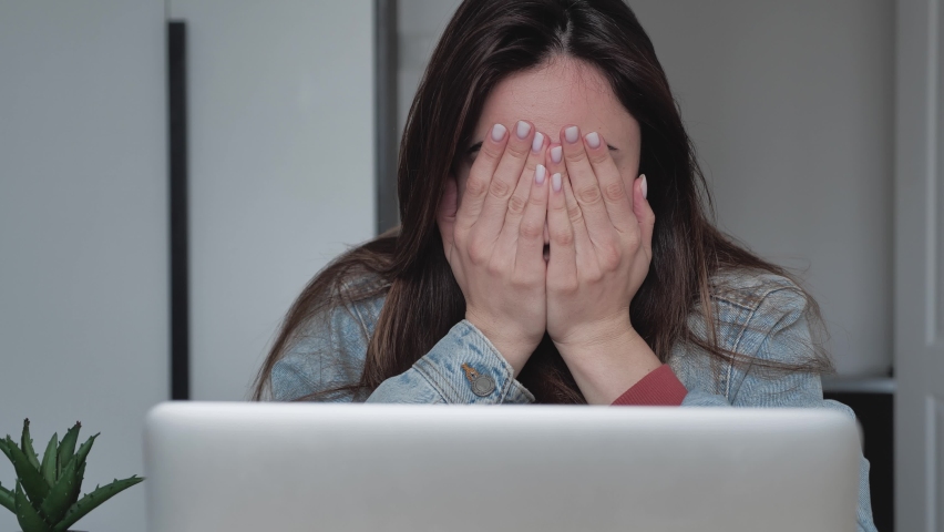 Stressed exhausted female young company employee suffering from head pain. I can't let this get to me | Shutterstock HD Video #1068489530
