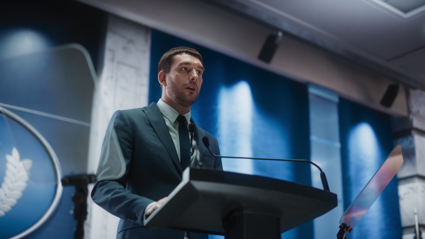 Portrait of an Young Organization Representative Speaking at Press Conference in Government Building. Press Officer Delivering a Speech at Summit. Minister Speaking at Congress Hearing. | Shutterstock HD Video #1068497849