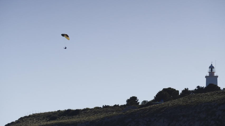 Paragliding. Extreme sport. Paraglider silhouette flying in the sky. Spain Alicante Santa Pola region.